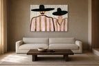 The Couple in Pink Stripes shown at 130 × 90 cm above a 230 cm linen sofa