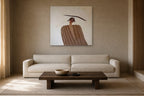 The Balancing Woman shown at 100 × 100 cm above a 230 cm linen sofa